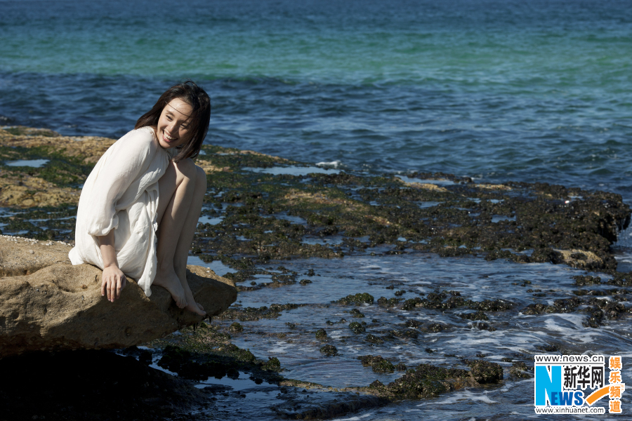 Actress Yuan Quan poses on beach
