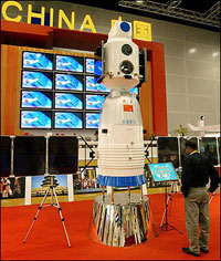 A man looks at a China-made Shenzou spaceship model on display in 2005. China regrets that the United States has rebuffed space cooperation with China, the head of China's space agency told his American counterpart in Washington. [AFP]