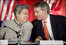 Chinese Vice Premier Wu Yi (L) confers with US Trade Representative Rob Portman at the Department of Commerce in Washington DC. China announced it would lift a ban on US beef imports and unveiled a raft of lucrative business deals in a bid to placate US complaints over their heavily skewed trade relationship(AFP