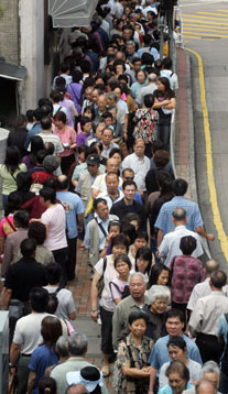 Local residents queue to take prospectuses for the initial public offering of Bank of China in Hong Kong May 18, 2006. 