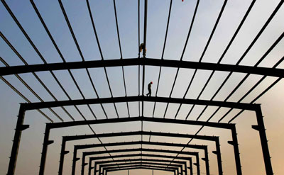 A labourer walks on a steel frame at a construction site in Nanjing, east China's Jiangsu province October 15, 2006.