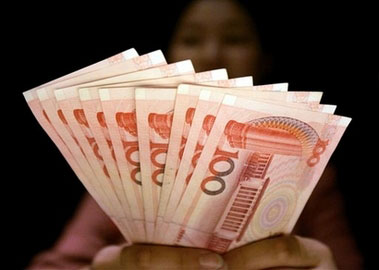 A clerk at an foreign currency exchange desk at a hotel shows Chinese yuan banknotes in this July 22, 2005 file photo taken in Shanghai, China. China's currency rose to a fresh high against the U.S. dollar on Monday, Nov. 27, 2006 as the central bank set its rate at 7.8402 yuan per dollar, the highest level since the current exchange system was set up in July 2005.