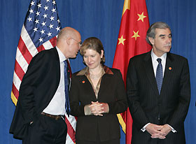 U.S. Treasury Secretary Henry Paulson (L) talks to Trade Representative Susan Schwab (C) as they and Commerce Secretary Carlos Gutierrez attend a news conference with the U.S. delegation for the first China-U.S. Strategic Economic Dialogue in Beijing December 15, 2006. 