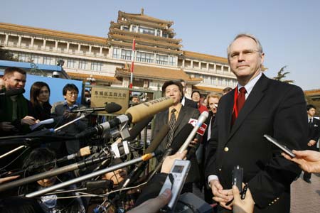 U.S. Assistant Secretary of State Christopher Hill, left, shares a laugh with U.S. Ambassador to China Clark Randt as they walk through a hotel before a third day of six party talks on North Korea's nuclear program, in Beijing Saturday Feb. 10, 2007. (AP