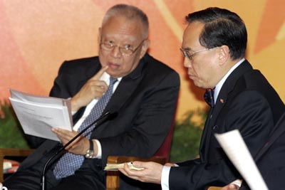 Hong Kong's Chief Executive Donald Tsang (R) speaks as former Chief Executive Tung Chee-hwa looks at him during the seminar marking the 10th anniversary of the entry into force of the Hong Kong Basic Law at the Great Hall of the People in Beijing June 6, 2007.