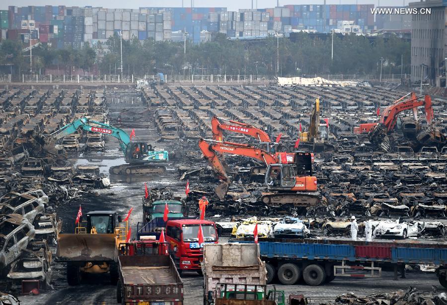 Burnt vehicles cleaned up in core blast area in Tianjin