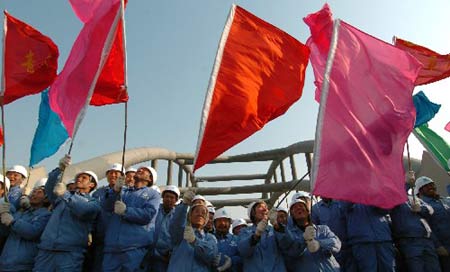 Photo taken on Dec. 16, 2007 shows the scene of celebration for the completion of the laying of track for the Beijing-Tianjin intercity high-speed railway in Tianjin, north China. Workers on Sunday completed the laying of track for the intercity high-speed railway between Beijing, China's capital, and the neighboring coastal city of Tianjin, the first of its kind in China. 