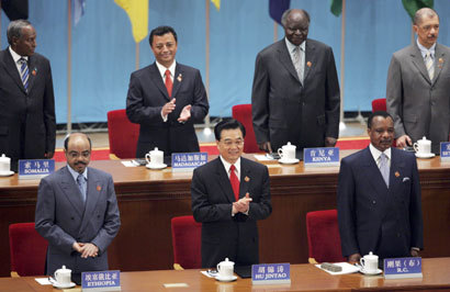 China's President Hu Jintao (C) applauds as he is flanked by African leaders at the opening ceremony of the China-Africa Summit at the Great Hall of the People in Beijing, November 4, 2006. China will provide $5 billion in loans and credits to Africa over the coming three years and double aid to the backward but resource rich continent by 2009, Hu said on Saturday. Hu is pictured with (L to R) Somali President Abdulahi Yusuf Ahmed, Ethiopian Prime Minister Meles Zenawi, Madagascar's President Marc Ravalomanana, Kenya's President Mwai Kibaki, President of the Republic of Congo Denis Sassou-Nguesso and Seychelles' President James Michel.