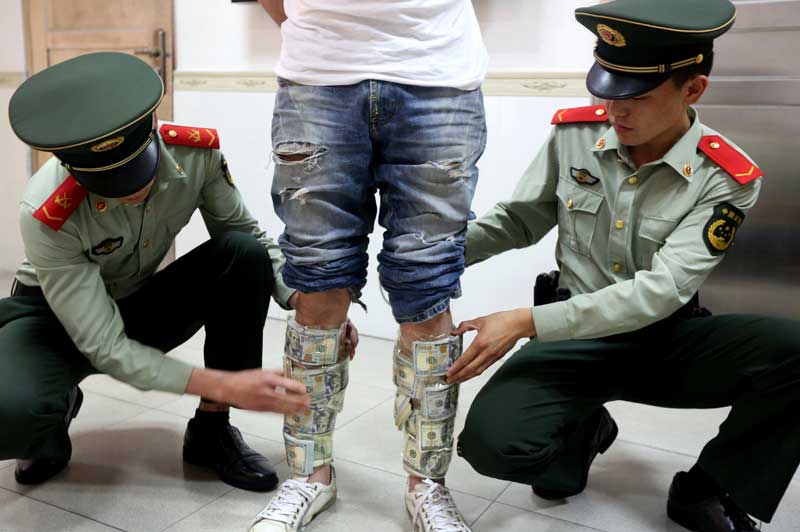 Man with cash stuck to his calves fails to cross border