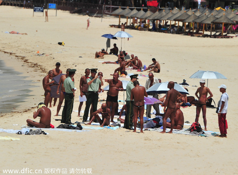 Two detained for swimming, sunbathing in the nude