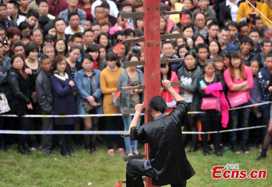 Climbing a ladder of knives to mark Double Third Day festival