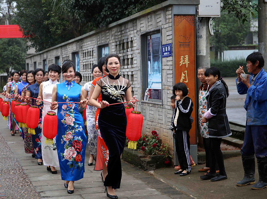Female officials put on cheongsams to promote village