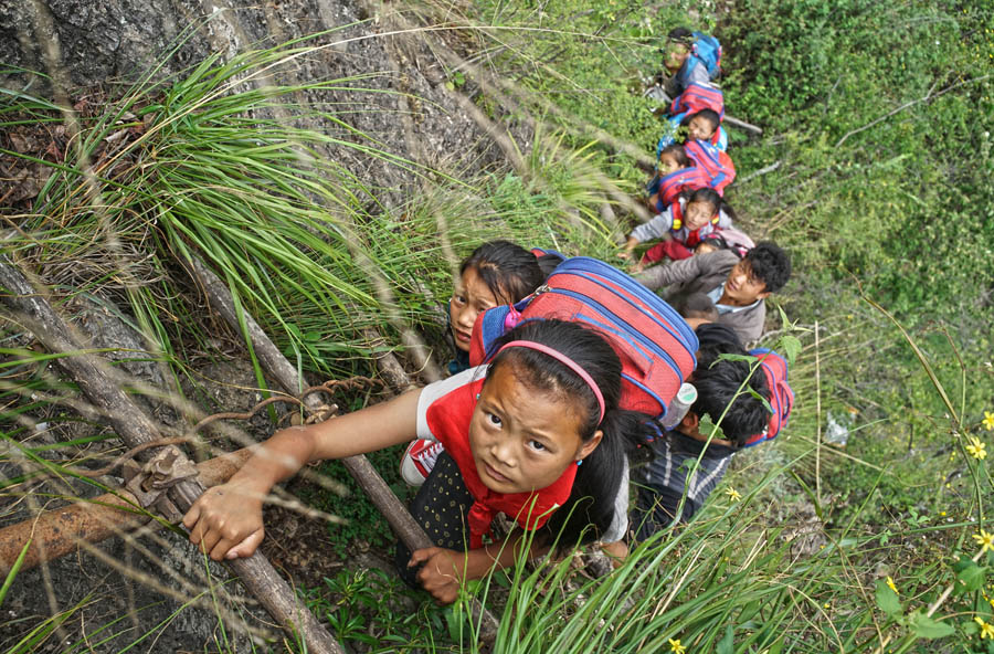 Children scale 800-meter cliff on way to school