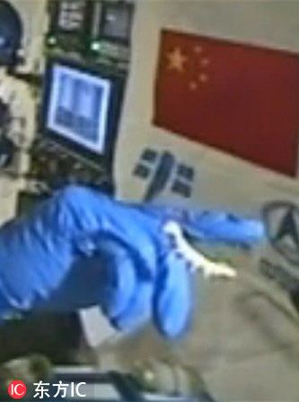 Astronaut plays with silkworms in Tiangong II