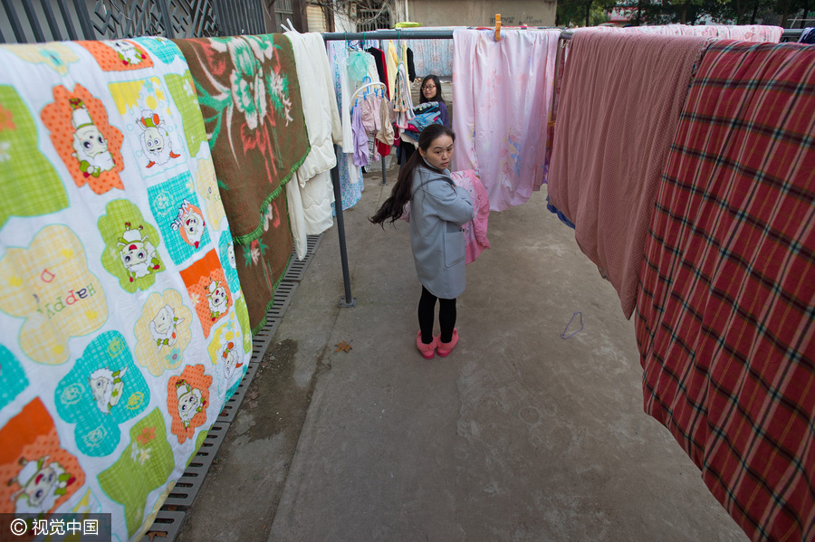 Students dry quilts and clothes in winter sunshine