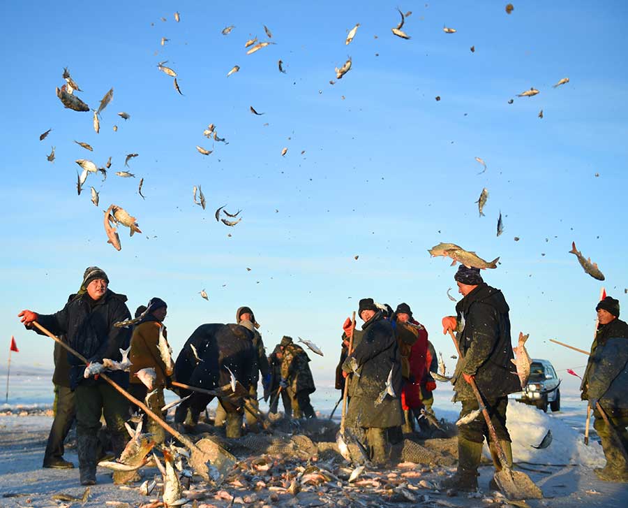 Winter fishing in ice-covered Hulun Lake in Inner Mongolia