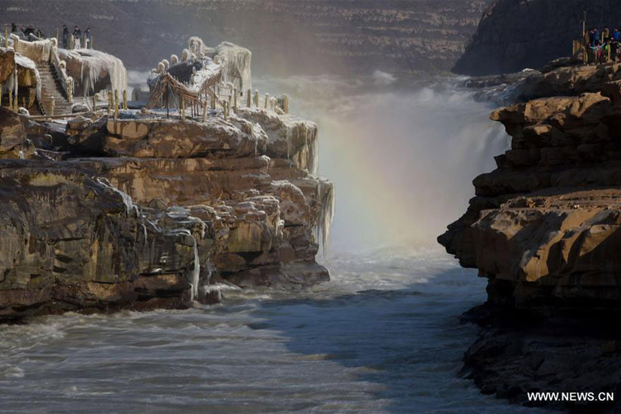 Visitors view frozen Hukou Waterfall on Yellow River