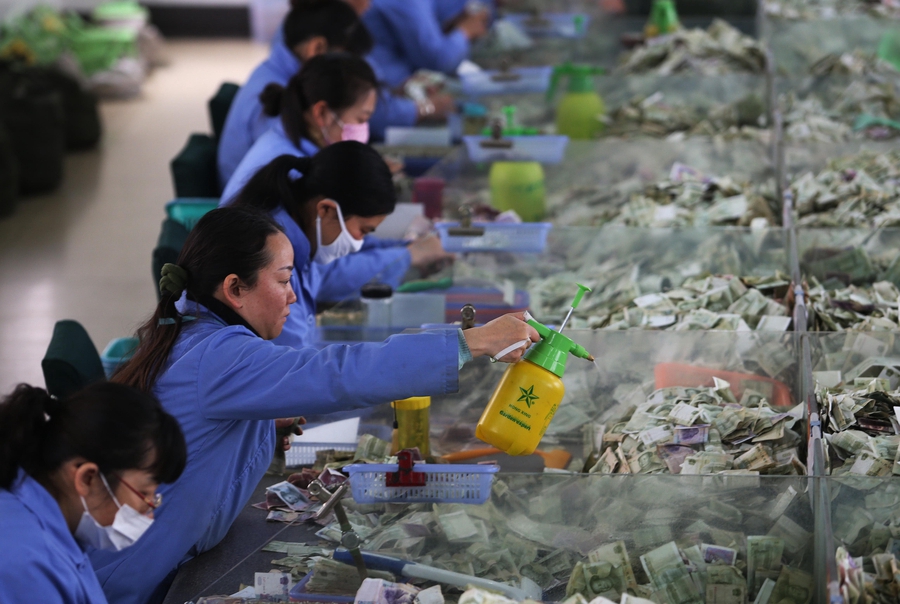 Cramped fingers, 24-hour security and sticky tape all part of a money counter's job