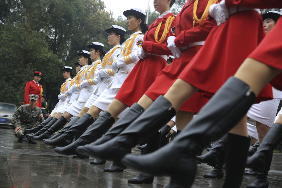 Marching in step: Female college students form flag-raising team