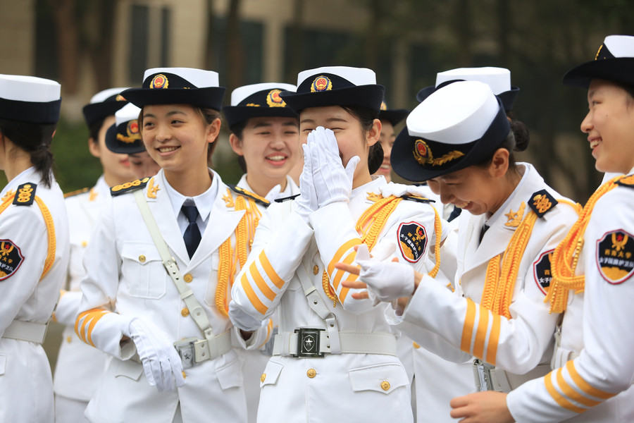 Marching in step: Female college students form flag-raising team