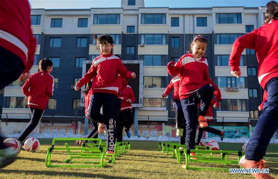 Primary school students participate in soccer training