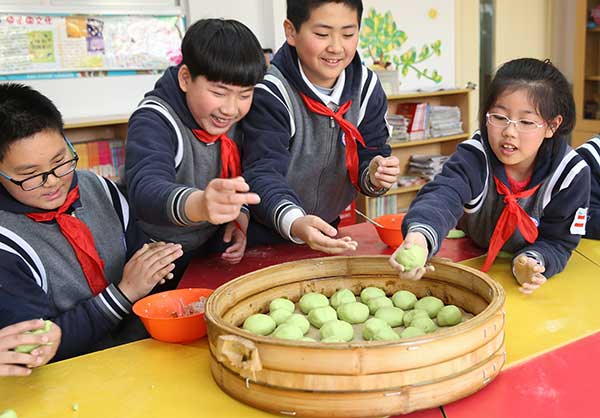 Young Chinese helping sticky rice balls make a comeback
