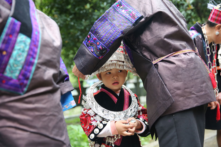 Miao people in traditional costume welcome experts in rural construction
