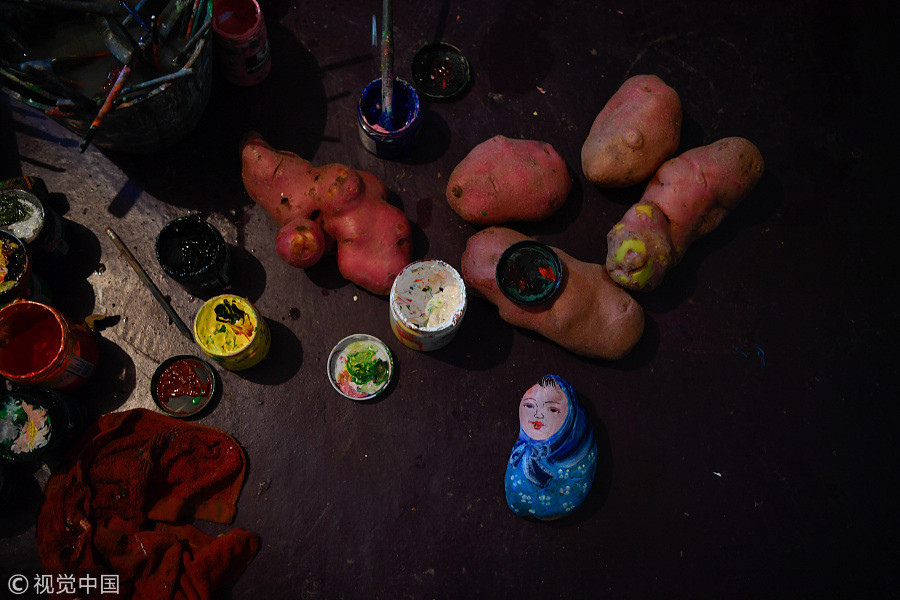 60-year-old villager paints potatoes for a living
