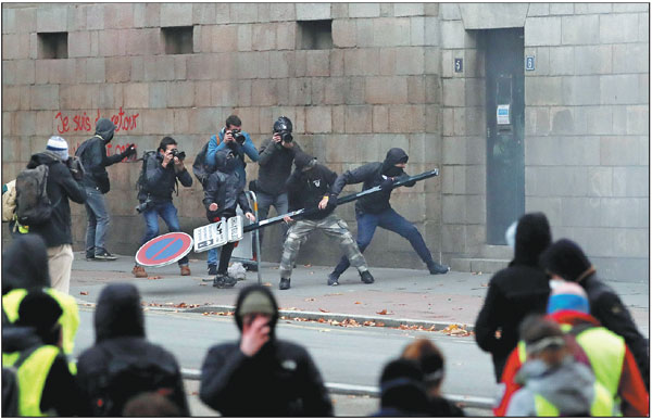 Tear gas fired as yellow vests mark anniversary