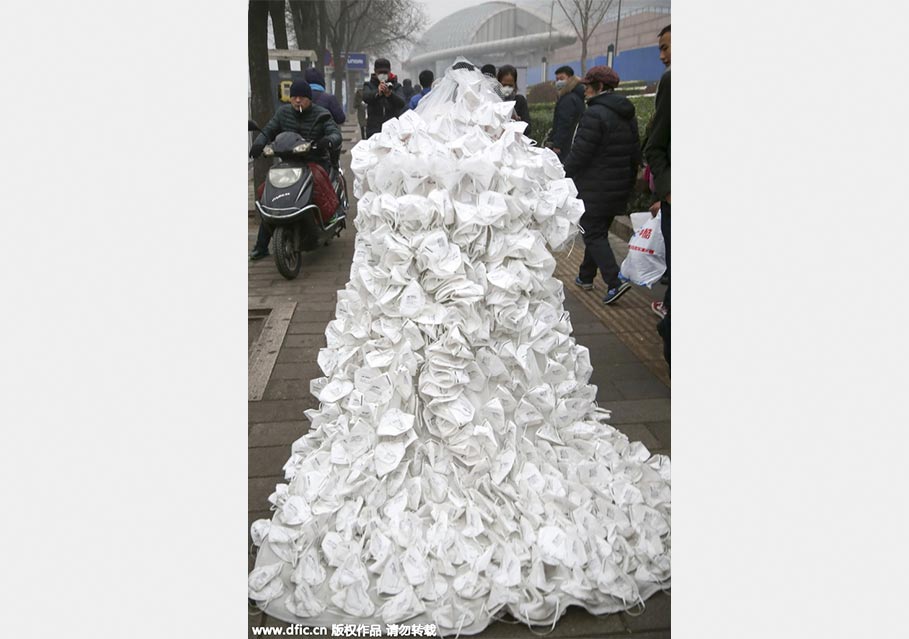 Artist appeals to public to combat smog with respirator wedding dress