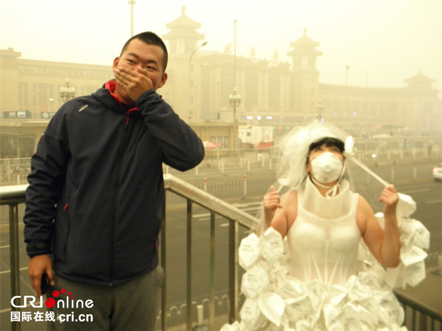 Artist appeals to public to combat smog with respirator wedding dress