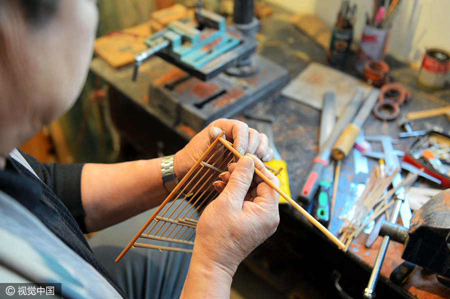 Folk artist dedicated to making bird cages