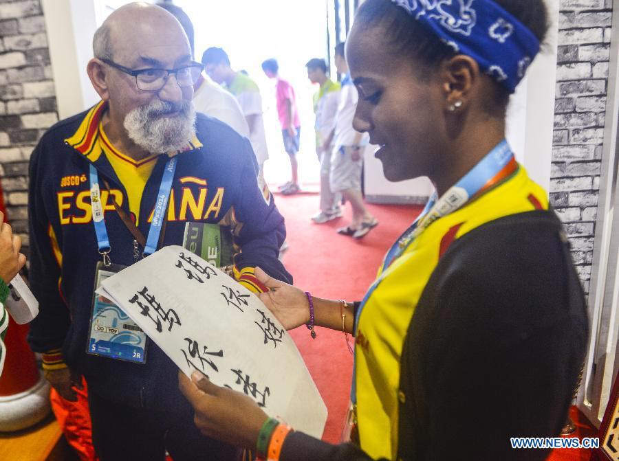 Athletes practice calligraphy at Youth Olympic Village