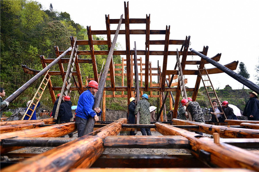 Ceremony held to start construction on a Tujia stilted house in C China