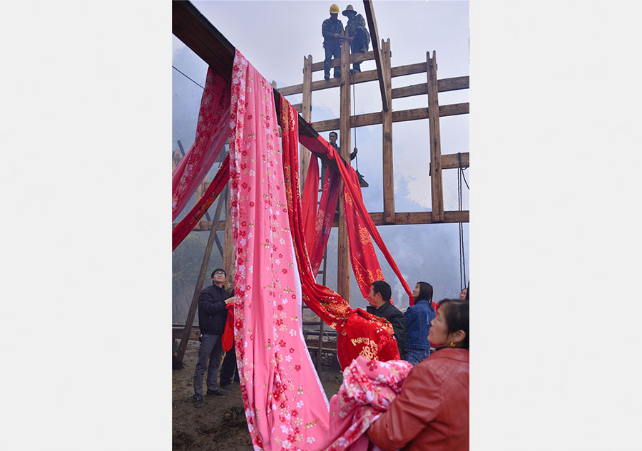 Ceremony held to start construction on a Tujia stilted house in C China