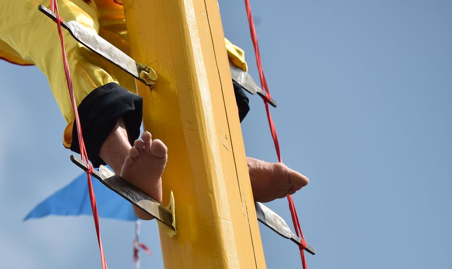 Stunt 'climbing on blades' performs in China's Fujian province