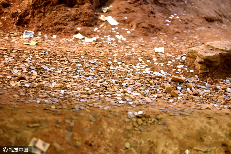 Tourists toss coins at ruins of Leifeng Pagoda