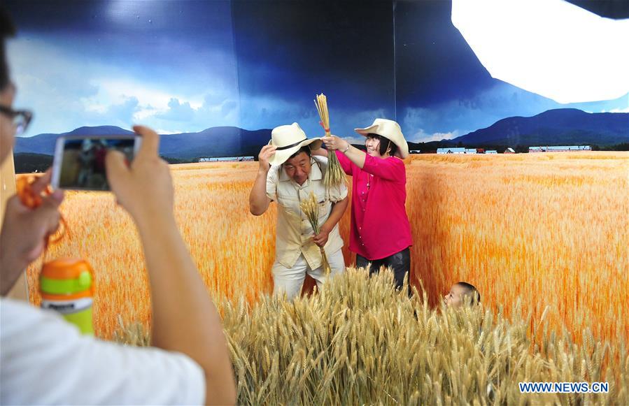 Visitors create their own photos at photo studio exhibition in Beijing