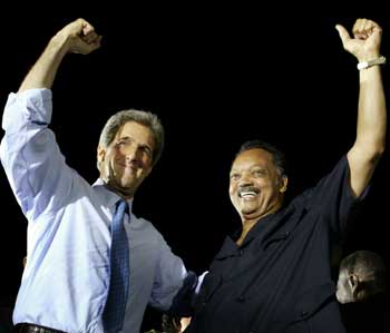 Democratic presidential nominee John Kerry is joined by the Reverend Jesse Jackson (R) onstage at a rally in Orlando, Florida, October 18, 2004, the first day of early voting in Florida. [Reuters]