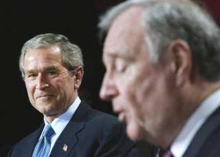 U.S. President George W. Bush (left) listens to Canadian Prime Minister Paul Martin duirng a joint news conference in Ottawa, Tuesday, Nov. 30, 2004. Bush is in Canada for a two-day visit. [AP] 