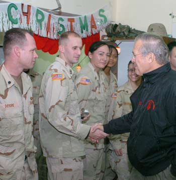 U.S. Secretary of Defense Donald Rumsfeld speaks to soldiers from the 67th Combat Support Hospital in Mosul, December 24, 2004. Rumsfeld paid a surprise Christmas visit on Friday to troops in Mosul, scene of the deadliest attack on Americans since last year's war to oust Saddam Hussein. [Reuters]