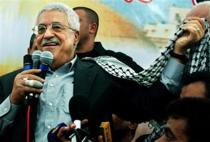 Interim Palestinian leader and presidential front-runner Mahmoud Abbas holds a kaffiyah, or traditional Arab headdress, while speaking to supporters during a campaign rally in the Rafah refugee camp, southern Gaza Strip, Saturday, Jan. 1, 2005. Palestinians will go to the polls in elections Jan. 9 to choose a successor to their late leader Yasser Arafat. [AP]
