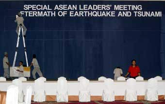 Indonesian workers prepare a room which will be used during the international tsunami summit at the Jakarta Convention Centre January 5, 2005. Global leaders gathering in Jakarta to discuss the tsunami that devastated countries around the Indian Ocean will try to draw lessons from the disaster, including looking at a future warning system. [Reuters]