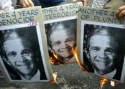 Filipino protesters burn pictures of U.S. President George Bush during a protest outside the U.S. Embassy in Manila January 20, 2005. The anti-U.S. group held a rally outside the U.S. Embassy on Thursday on the occasion of the inauguration of U.S. President George Bush, and condemned the Bush administration for war mongering and human rights violations. [Reuters]