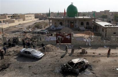 U.S. soldiers and the Iraqi police secure the area following a car bomb explosion in front of a Shiite mosque in Baghdad, Friday, Jan 21, 2005. A car bomb exploded outside a Shiite mosque in Baghdad Friday where worshippers were celebrating a major Muslim holiday, killing at least 13 people and wounding 40, police and hospital officials said, the country's latest violence in the lead-up to this month's elections. [AP]