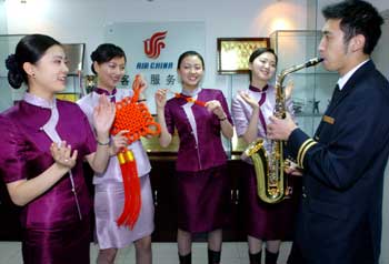 Air China attendants rehearse short programs to entertain passengers on nonstop flights across the Taiwan Straits during the Spring Festival in Beijing January 27, 2005. [newsphoto]