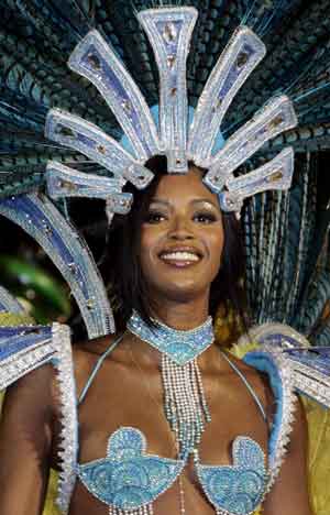British super model Naomi Campbell dances atop a float presented by the Portela samba school on the second night of the premier Carnival parade in Rio de Janeiro's Sambadrome, early February 8, 2005. Rio's showbiz-like Carnival party went into its final night with seven samba schools winding up the most expensive parade yet. 