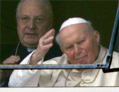 Pope John Paul II, flanked by Vatican Secretary of State card. Angelo Sodano, waves to the small crowd from behind a window at Rome's Gemelli Polyclinic Hospital, Sunday, Feb. 27, 2005. [AP]