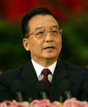 Premier Wen Jiabao, shown in the TV screen, delivers his government work report at the third session of the 10th National People's Congress in the Great Hall of the People in Beijing March 5, 2005. Wen stressed the goal of peaceful reunification of the motherland in his annual address to the parliament on Saturday and pledged to keep the world's sixth-largest economy growing without overheating. [newsphoto]