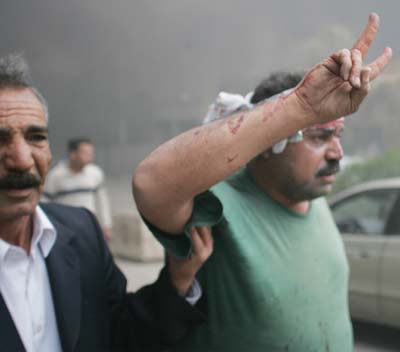 An injured man is evacuated after a powerful suicide bomb exploded in central Baghdad early March 9, 2005. [Reuters]